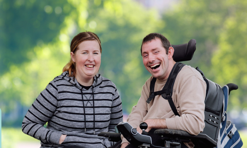 IMAGE: A Client and Disability Support worker are in the park talking and laughing