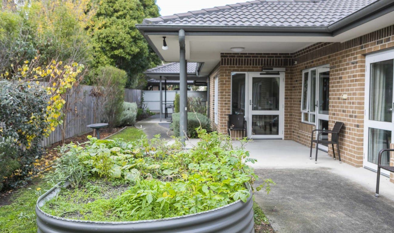 Image of a back patio area with a raised garden bed.