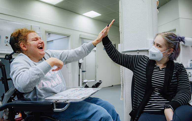 Image: Yooralla client and Yooralla Disability Support worker high-five
